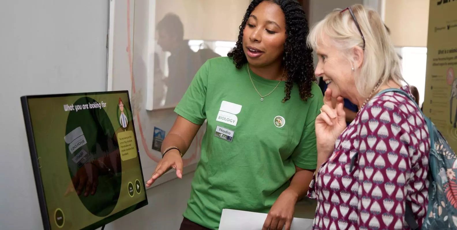 A researcher and visitor at the Seismic Senses exhibit, featured at the 2025 Royal Society Summer Science Exhibition